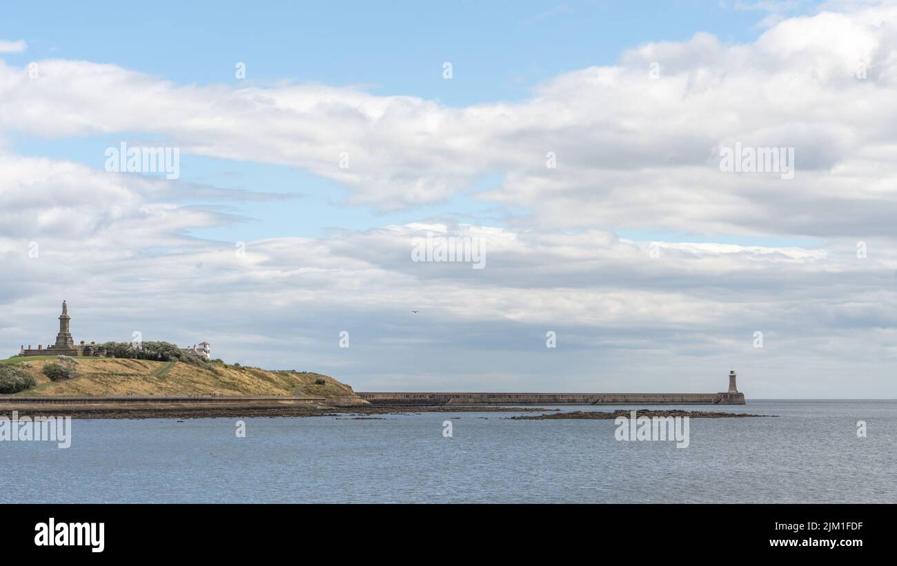 A riverscape view of Tynemouth lighthouse and the Collingwood monument