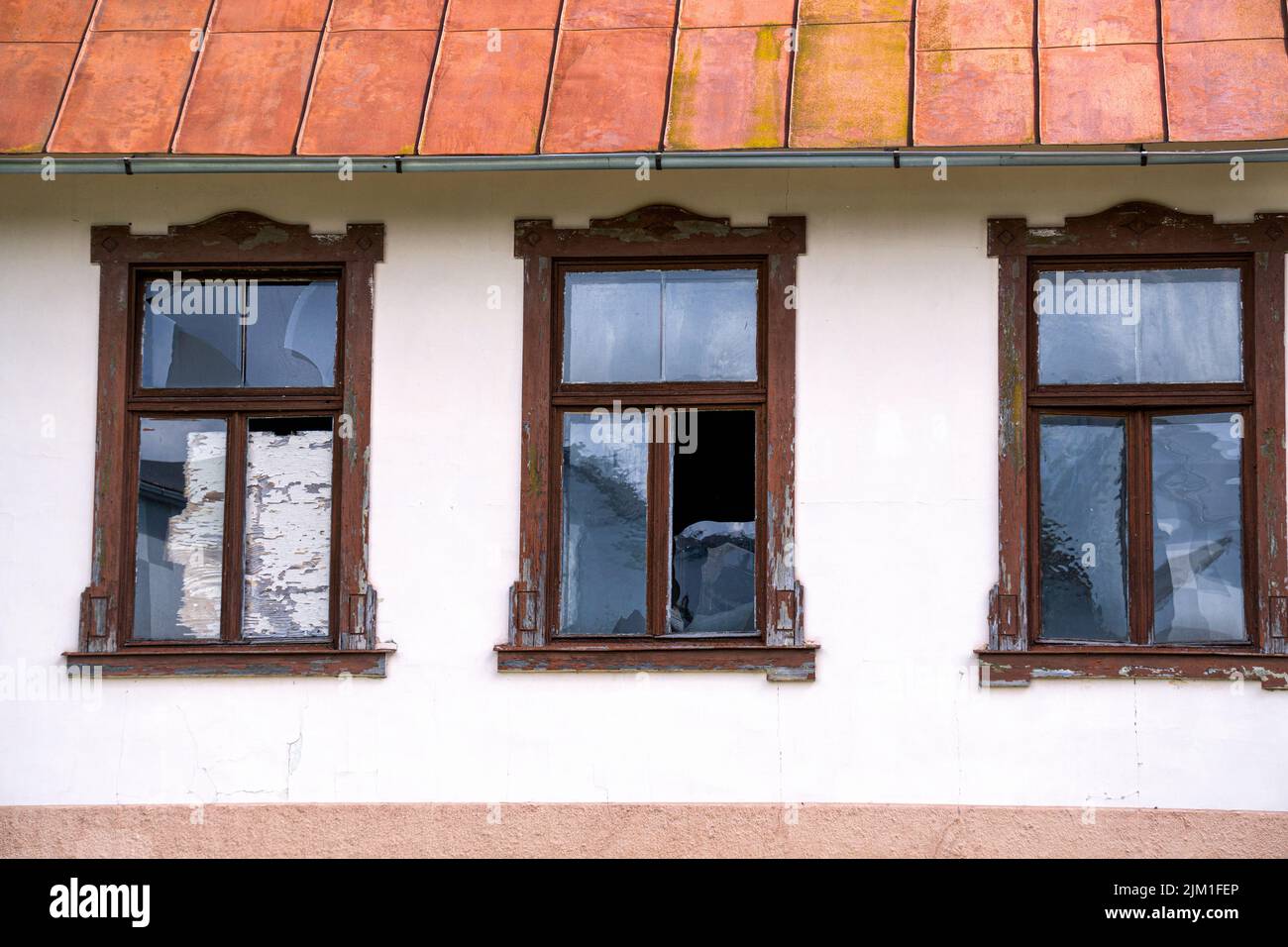 Broken windows in an old building against a white wall Stock Photo - Alamy