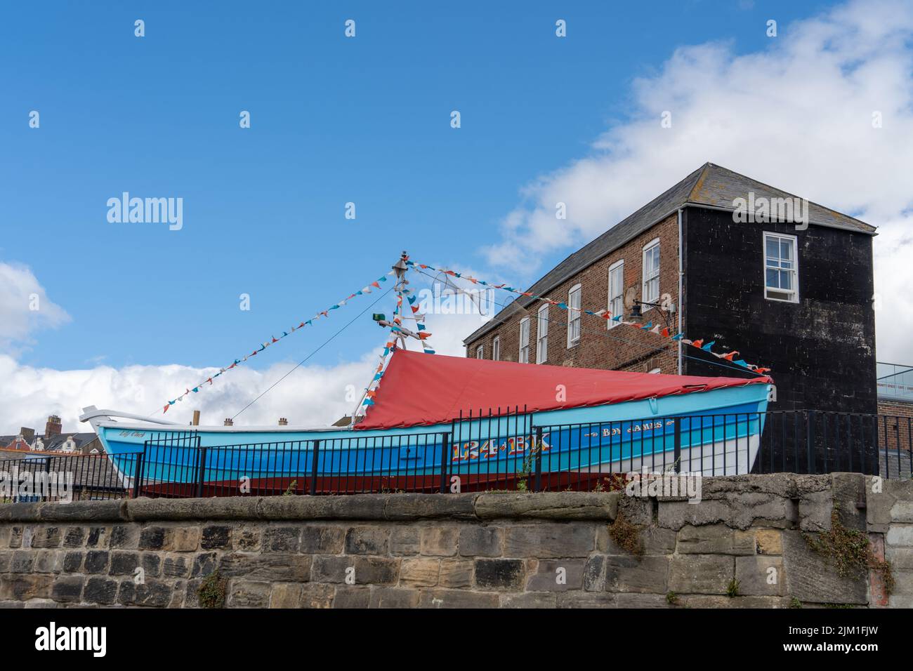 Brightly coloured restored fishing boat at Old Low Light on the Fish Quay in North Shields, North Tyneside, UK, near the River Tyne. Stock Photo