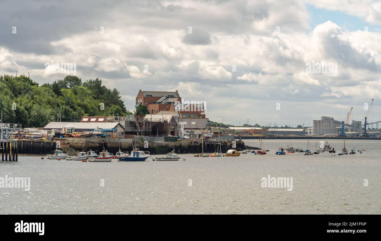 A riverscape view of boats in the River Tyne and waterfront buildings in South Shields, South Tyneside, UK. Stock Photo