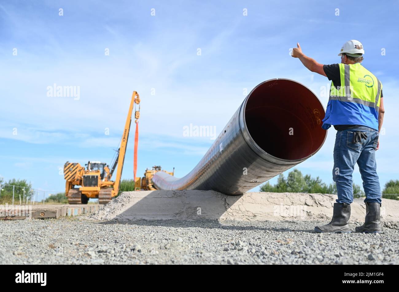 Friedeburg, Germany. 04th Aug, 2022. A construction machine lays pipes