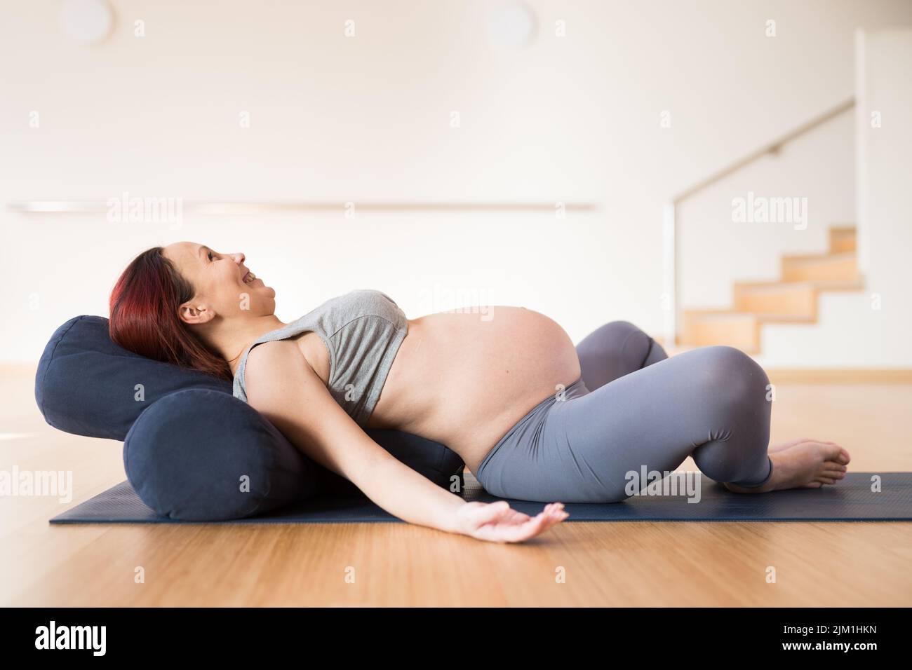 pregnant woman is engaged in yoga. Reclined Goddess Pose or Supta Baddha Konasana Stock Photo