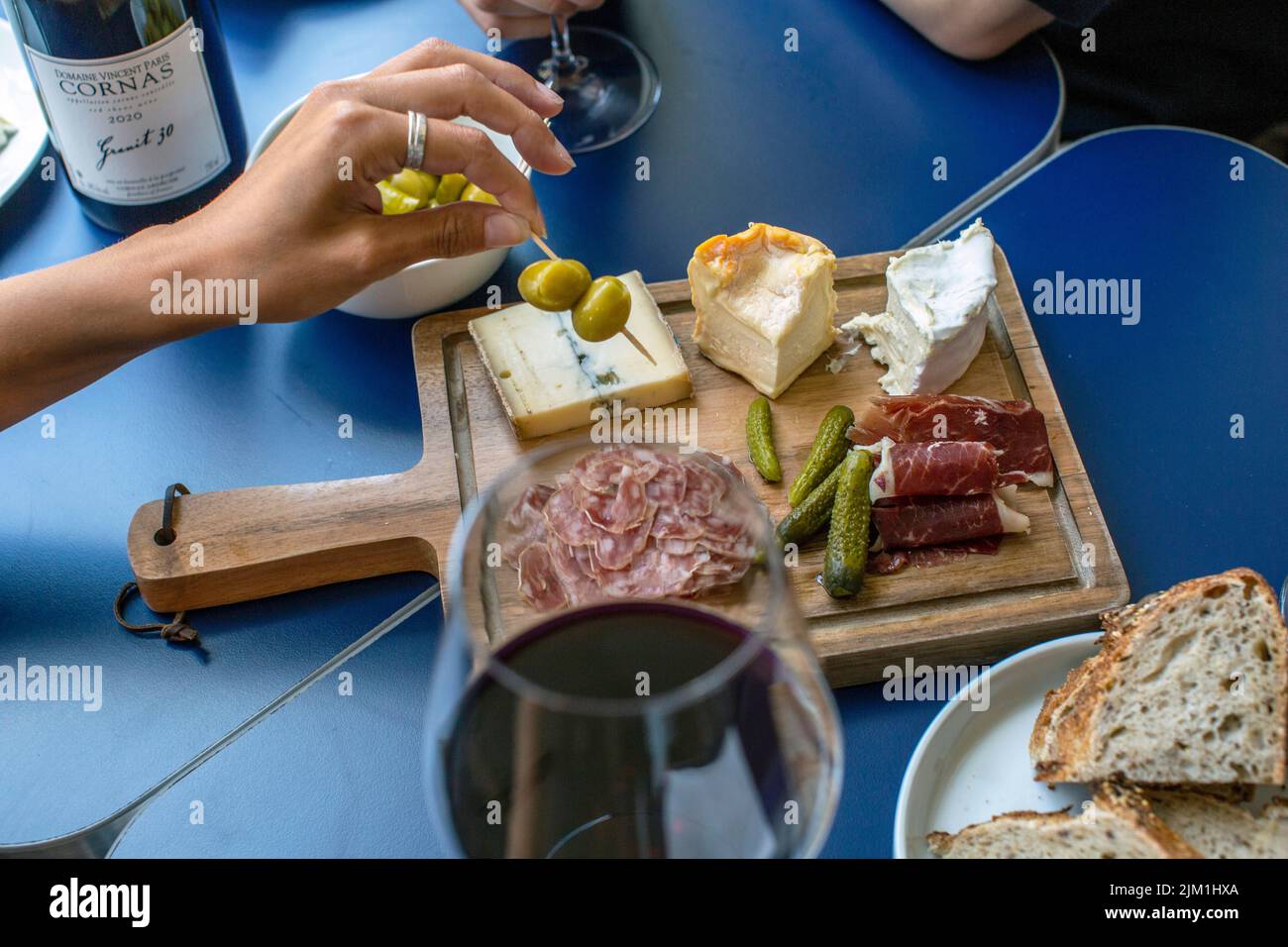 Red wine ,charcuterie and cheese board, red wine, snacks and peoples hands Stock Photo