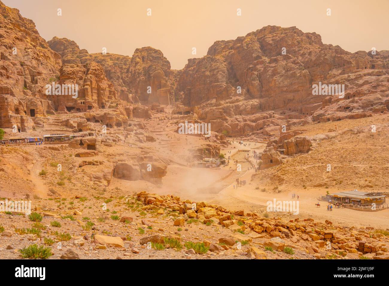 Looking towards the street of Facades in Petra Jordan. With a dust storm blowing through Stock Photo
