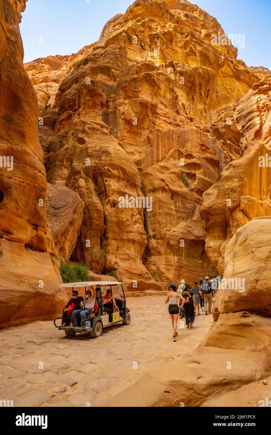 Crowds walking up Al-Siq canyon. From the entrance to Petra Jordan. Stock Photo