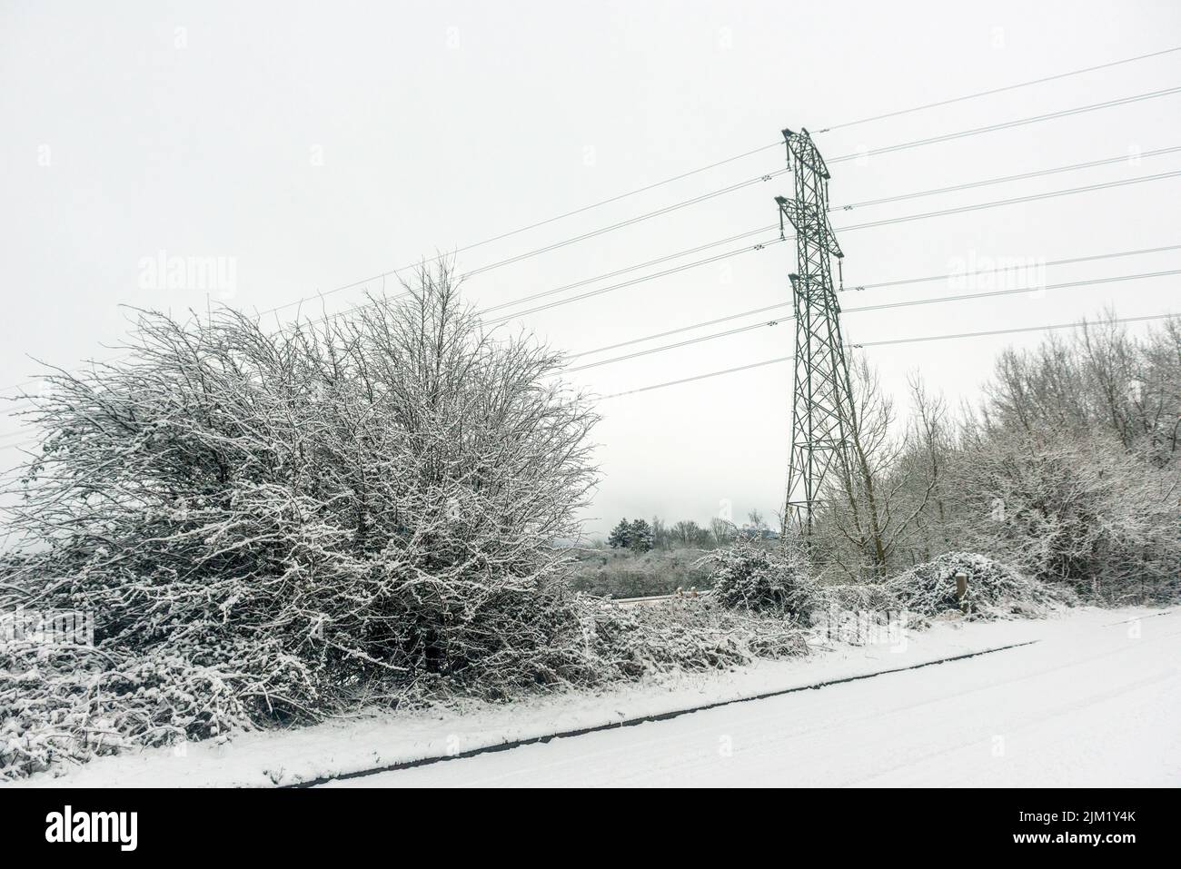 Electricity pylons in winter snow Stock Photo