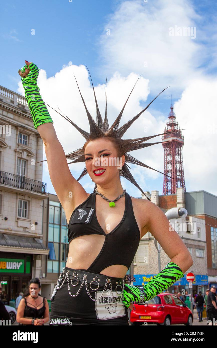 Blackpool, Lancashire, UK. 4th Aug 2022. Erin Micklow, American  SAG-AFTRA actress, wardrobe stylist, host YouTuber influencer. Punk subculture, ideologies, fashion, with Mohican dyed hairstyles and colouring at the Punk Rebellion festival at The Winter Gardens. A protest against conventional attitudes and behaviour, a clash of anti-establishment cultures,  mohawks, safety pins and a load of attitude at the seaside town as punks attending the annual Rebellion rock music festival at the Winter Gardens come shoulder to shoulder with traditional holidaymakers. Stock Photo