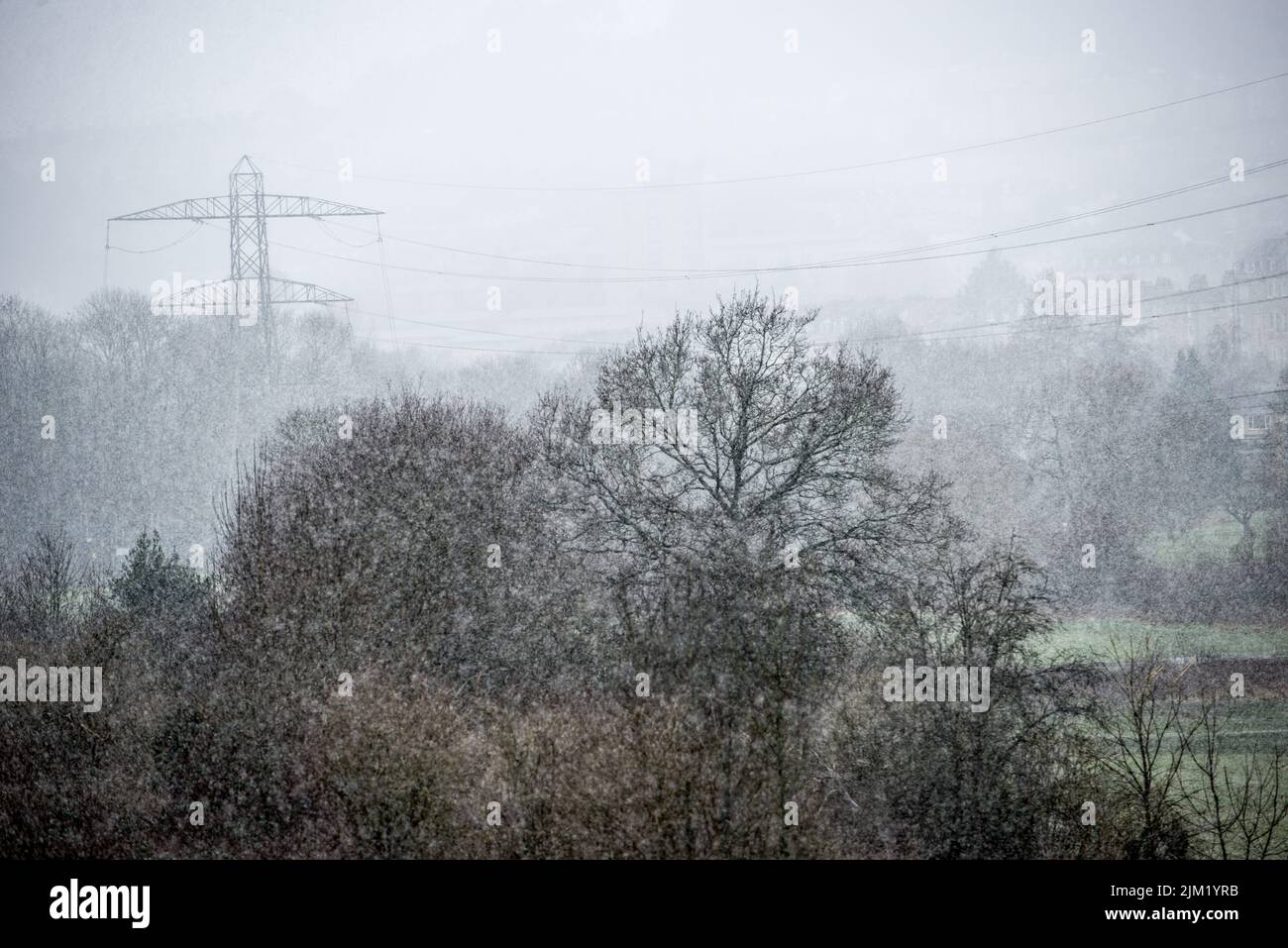 Electricity pylons in winter snow Stock Photo