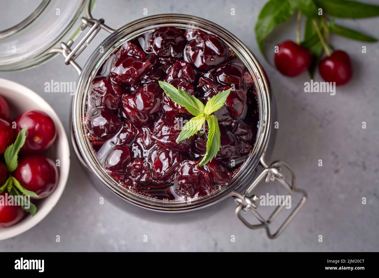 Jars with freshly homemade cherry jam, sour cherry jam, Turkish name; Visne receli Stock Photo