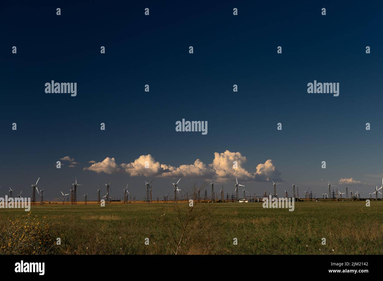 Wind Turbines Windmill Energy Farm on green field and blue sky Stock ...