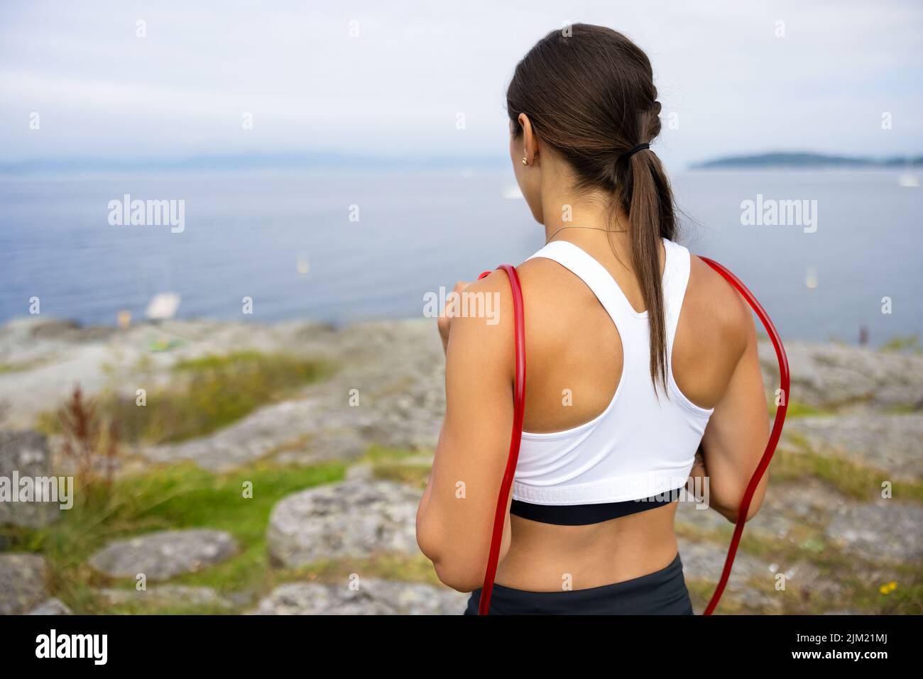 Athlete Doing Outdoor Workout With Jumping Rope Stock Photo
