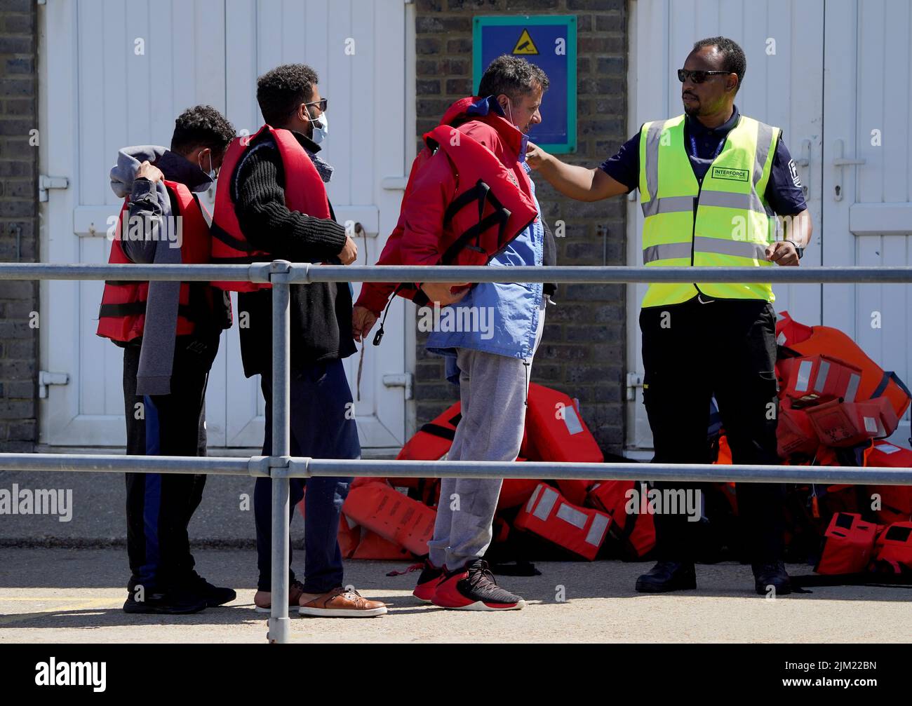 A group of people thought to be migrants are brought in to Dover, Kent, following a small boat incident in the Channel. Picture date: Thursday August 4, 2022. Stock Photo