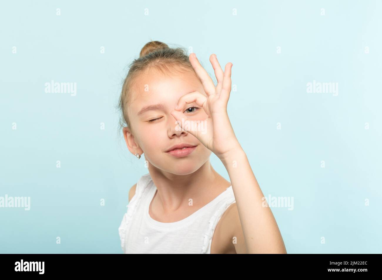 ok gesture funny smiling girl look through finger Stock Photo Alamy