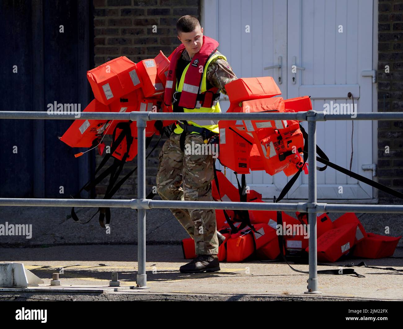 Life vests used by a group of people thought to be migrants are moved away from the dockside in Dover, Kent, following a small boat incident in the Channel. Picture date: Thursday August 4, 2022. Stock Photo