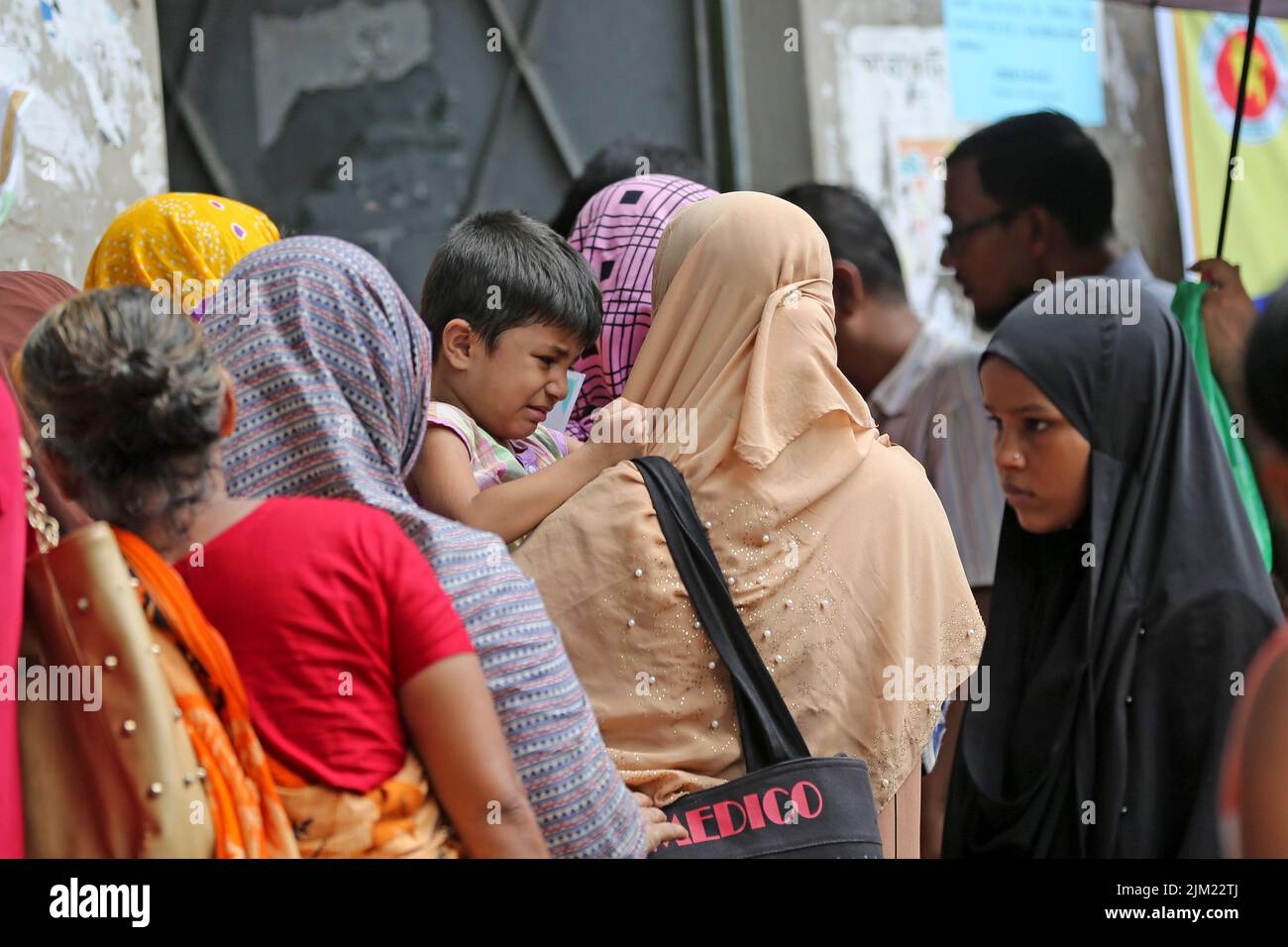 Overcrowding of people at the TCB biponon kendra [food sell center] in Ward No. 10 of Motijheel in the capital to collect products,Bangladesh. As the Stock Photo