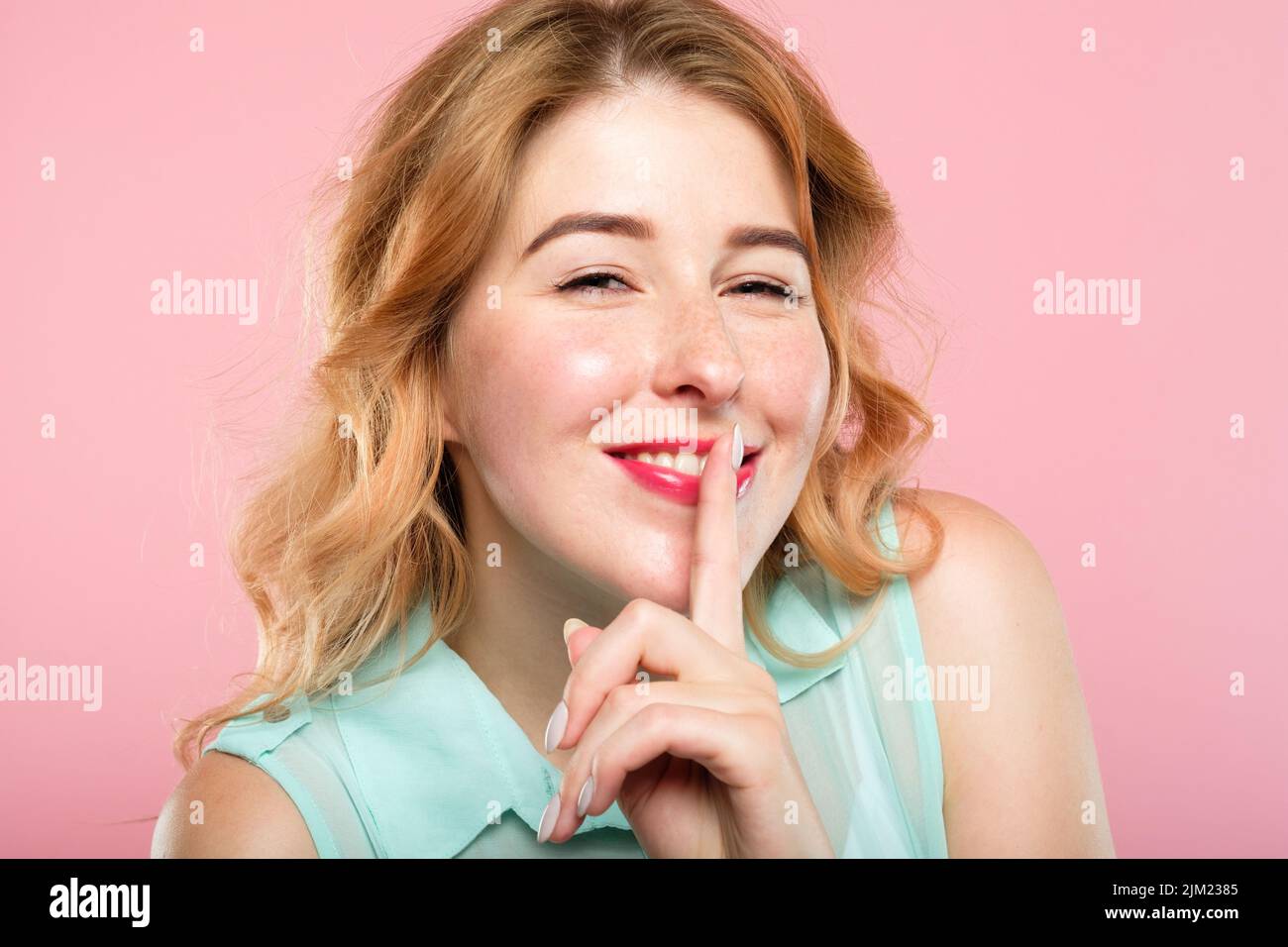 girl keep secret mystery finger on lips Stock Photo