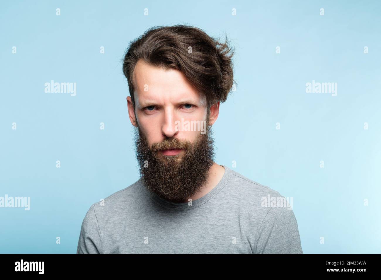 emotion expression serious frowning grumpy man Stock Photo