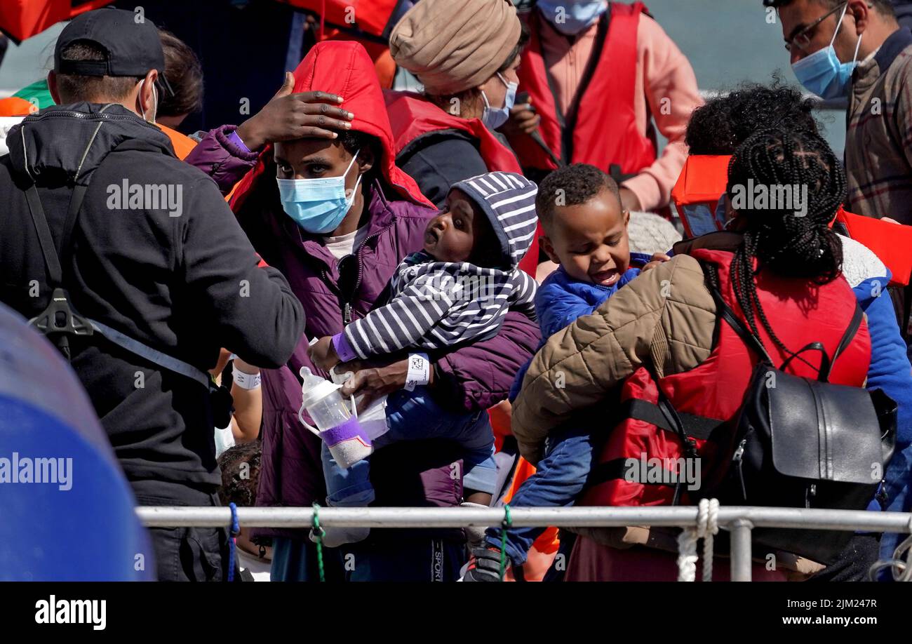 EDITORS NOTE: The PA Picture Desk has been unable to gain the necessary permission to photograph children under 16 on issues involving their welfare. This image has been provided unpixelated for customers to pixelate in their own style. Young children amongst a group of people thought to be migrants as they are brought in to Dover, Kent, following a small boat incident in the Channel. Picture date: Thursday August 4, 2022. Stock Photo