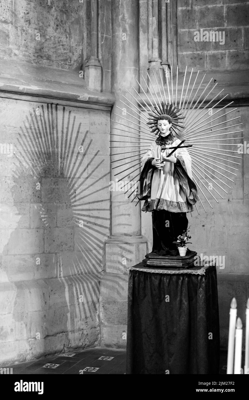 Black and white photo of statue of catholic young male saint inside ancient church in Naples, Italy Stock Photo