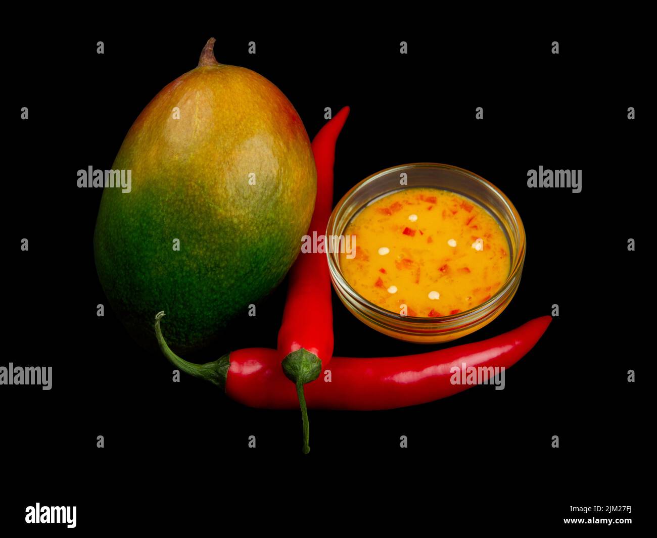 Yellowgreen Mango, chili and mango chili jam on pure black background