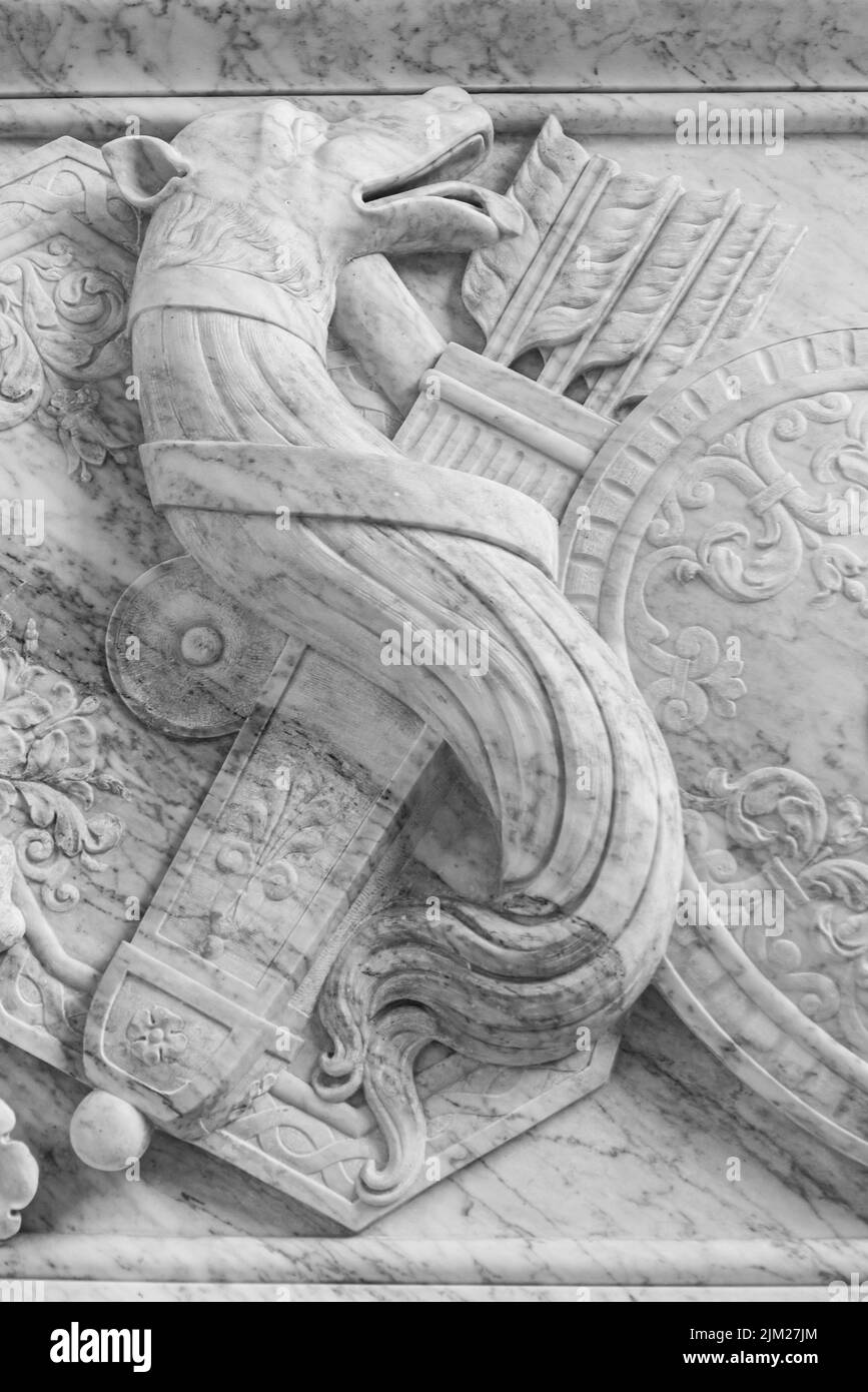 Black and white photo showing in close-up a decorated bow and arrow case carved on ancient building wall Stock Photo