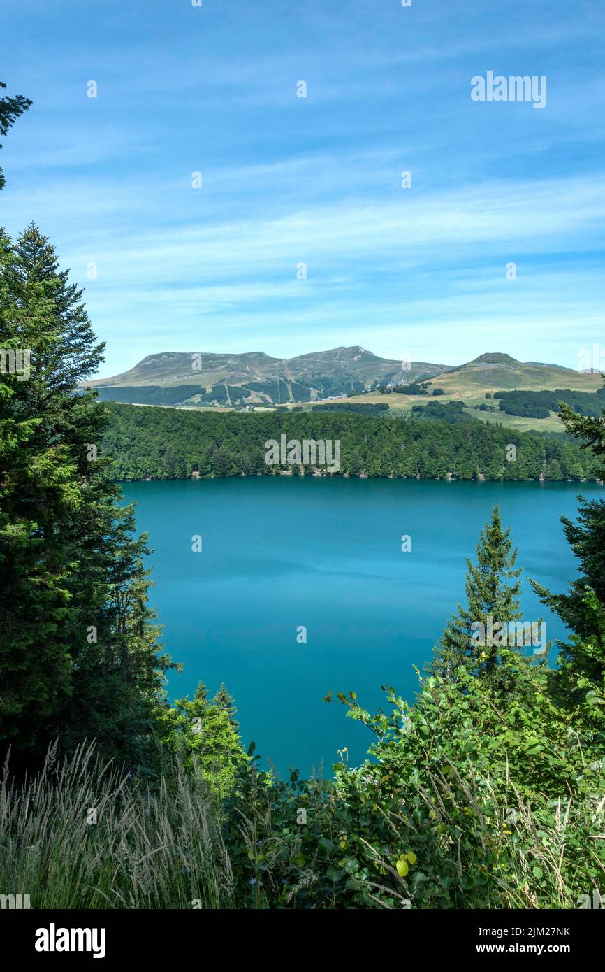 View on Volcanic Pavin lake located in the Regional Natural Park of Auvergne Volcanoes, Sancy massif in the background, Auvergne, France, Europe Stock Photo