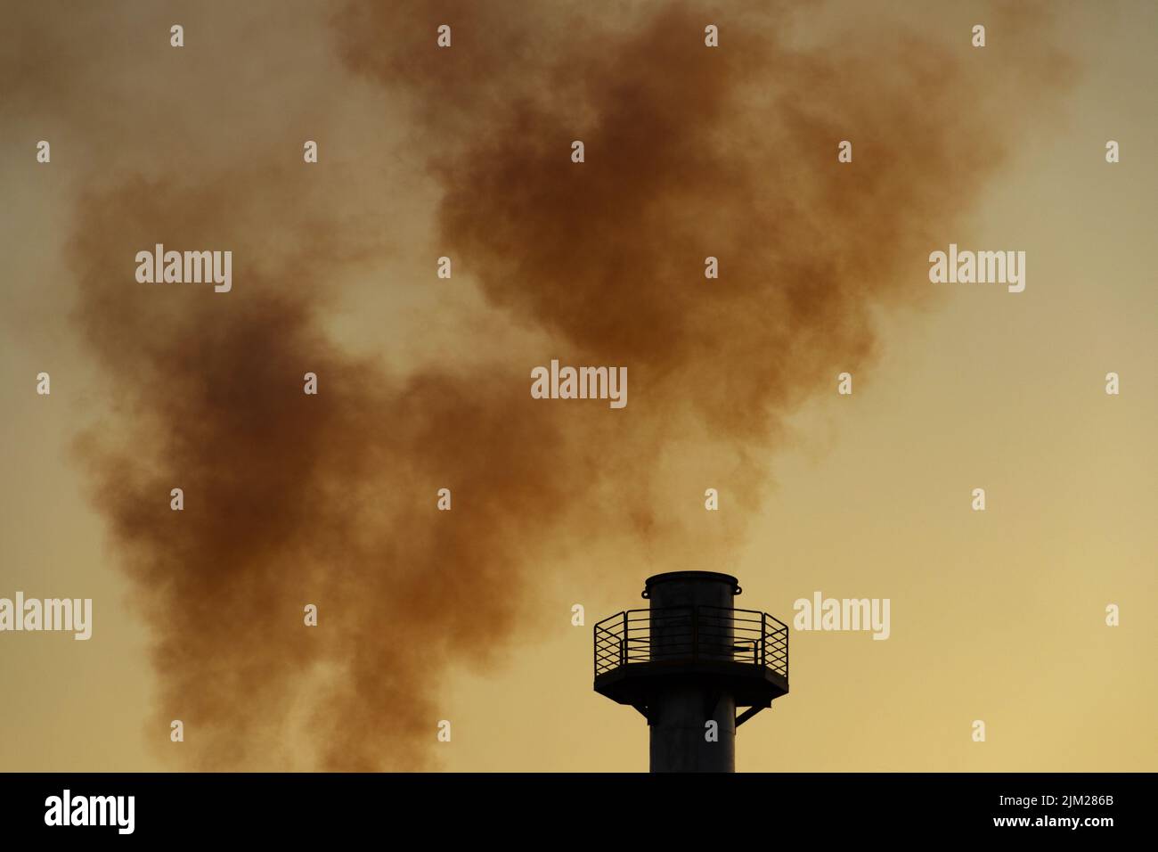Goiania, Goiás, Brazil – August 04, 2022: Smoke rising from the chimneys of a factory. Factory smoke pollution with the sky in the background. Stock Photo