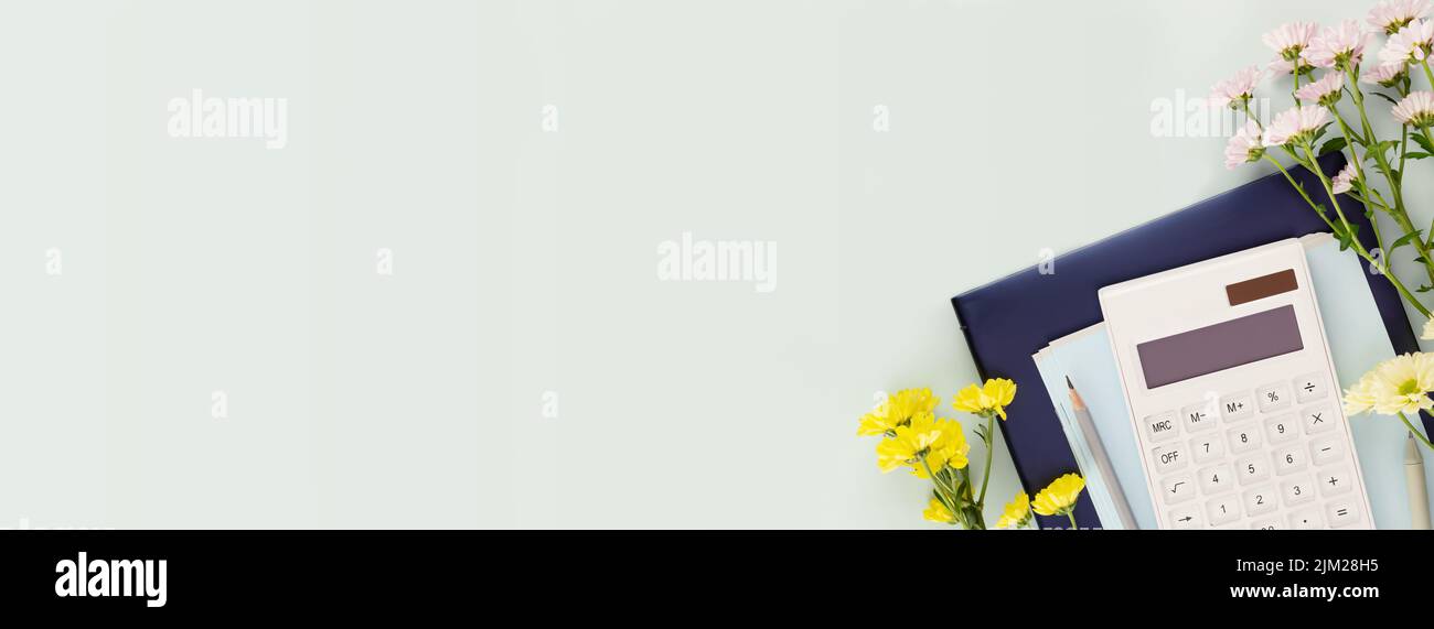 Holiday, education banner with school supplies, calculator on a tablet with flowers on a light blue background with place for text. Back to school con Stock Photo