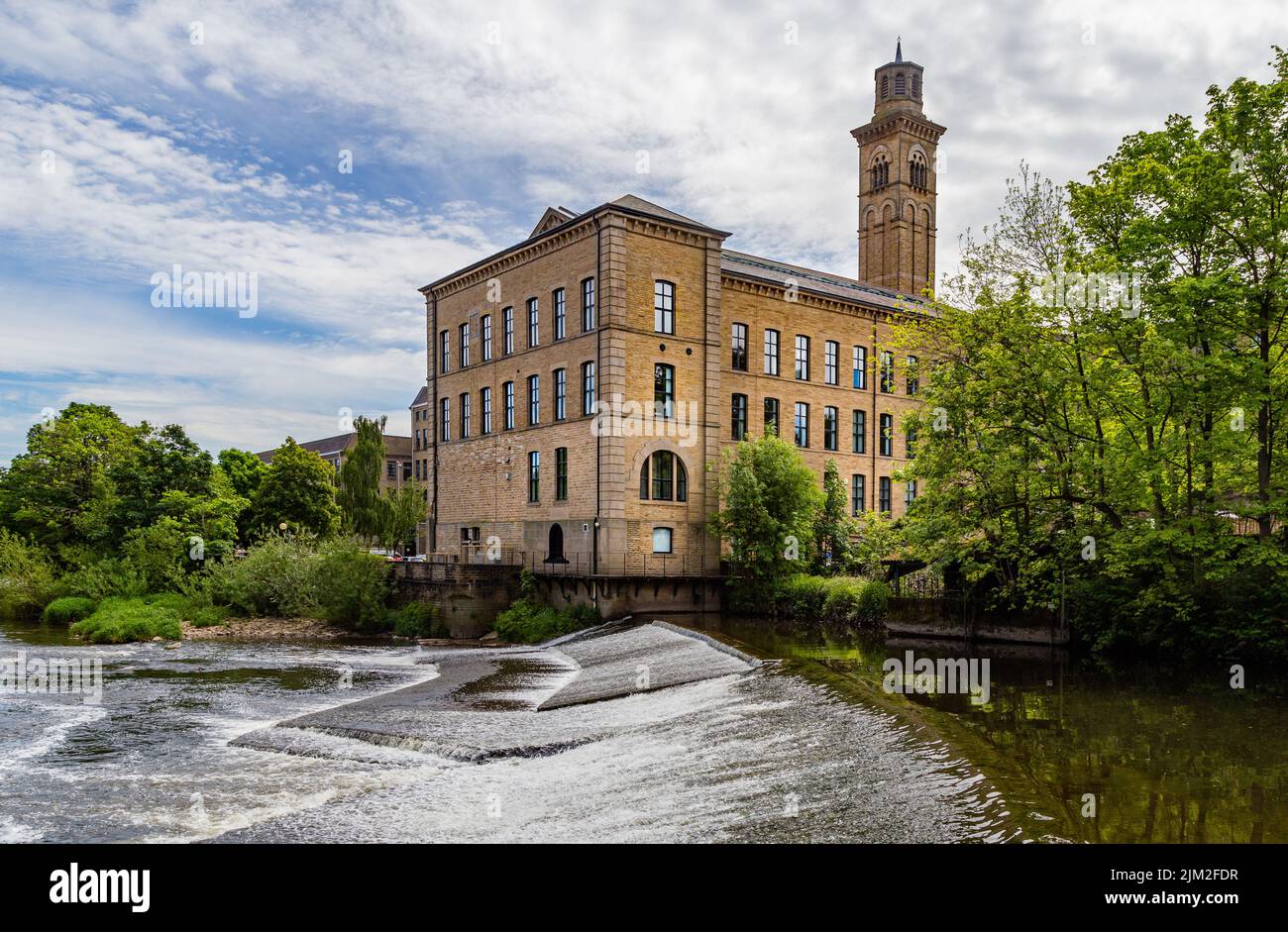 Salts Mill in Saltaire, Yorkshire, seen from the opposite side of the River Aire. The river flows between Saltaire and Baildon. Stock Photo