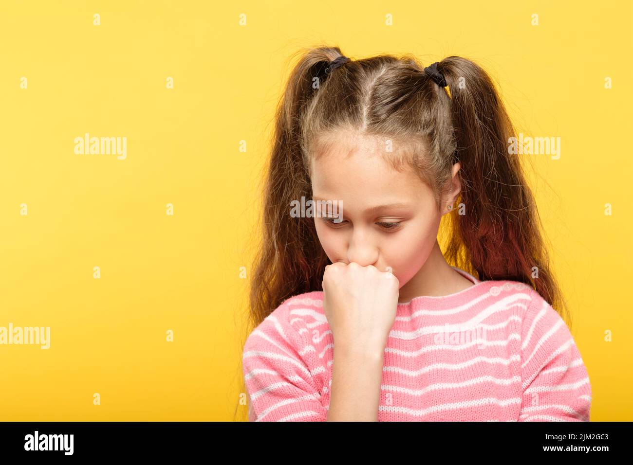 sad pensive thoughtful girl looking down emotion Stock Photo