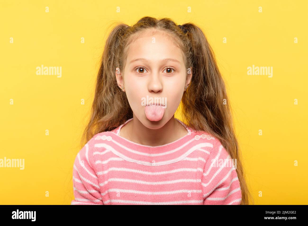 girl sticking tongue out cute antics frolicking Stock Photo Alamy
