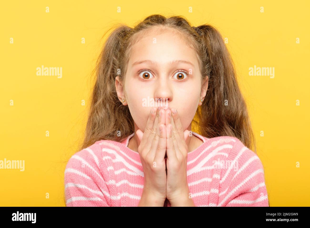 surprised astonished girl covering mouth reaction Stock Photo