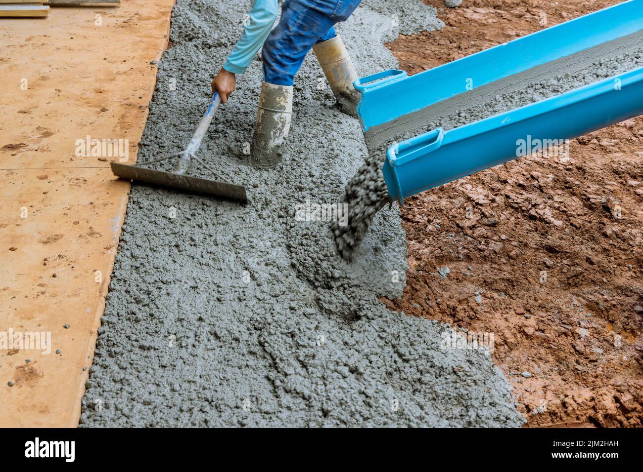 Process of pouring cement on a new driveway for a residential property