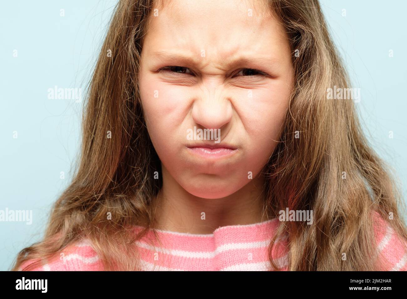 dislike unimpressed girl grimace wrinkle nose Stock Photo