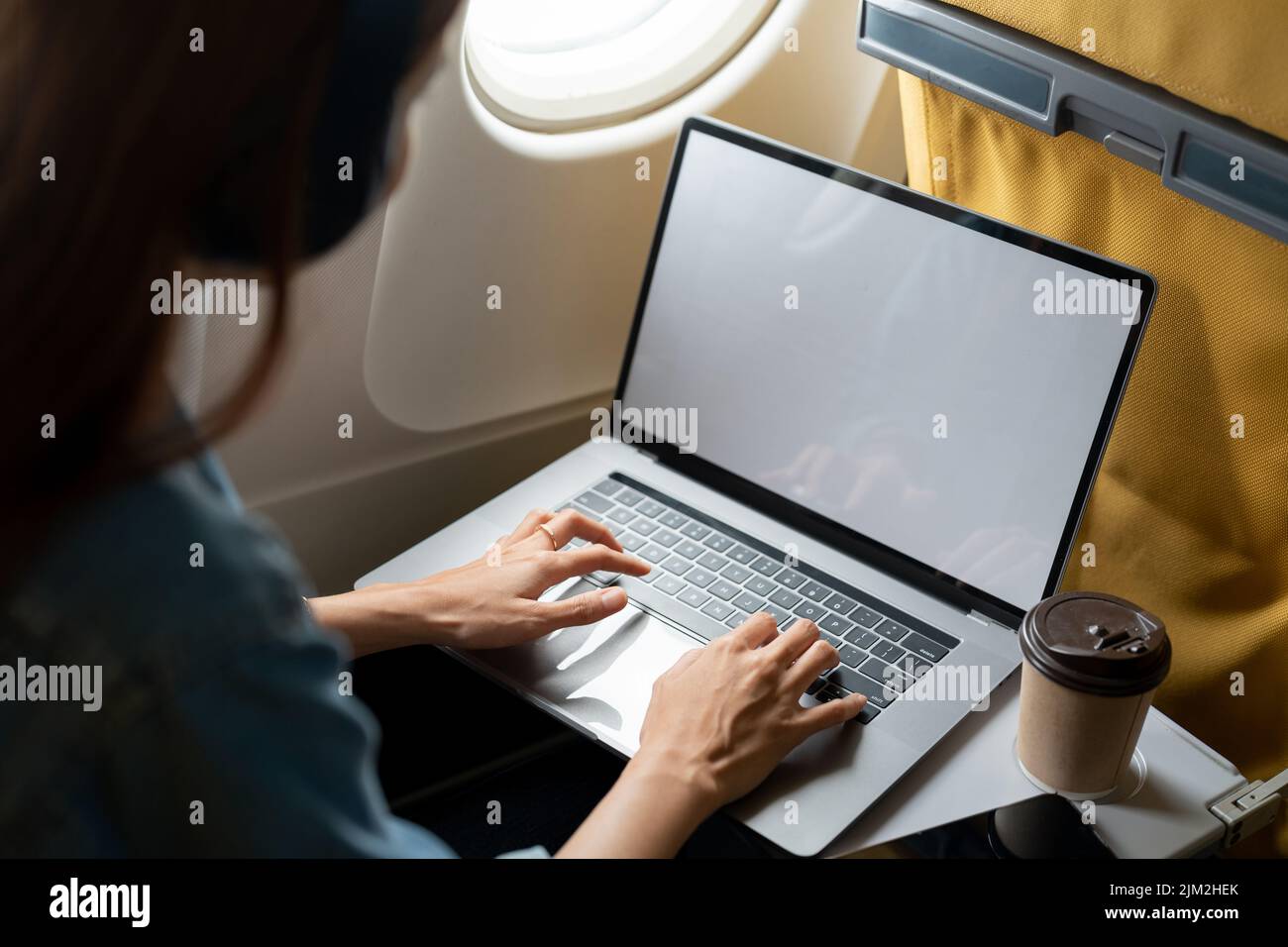 Beautiful asian travel woman using laptop computer in airplane Stock Photo