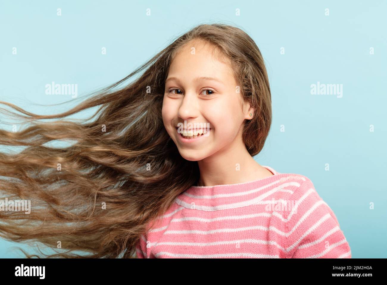 adolescent girl wavy hair flying haircare kids Stock Photo