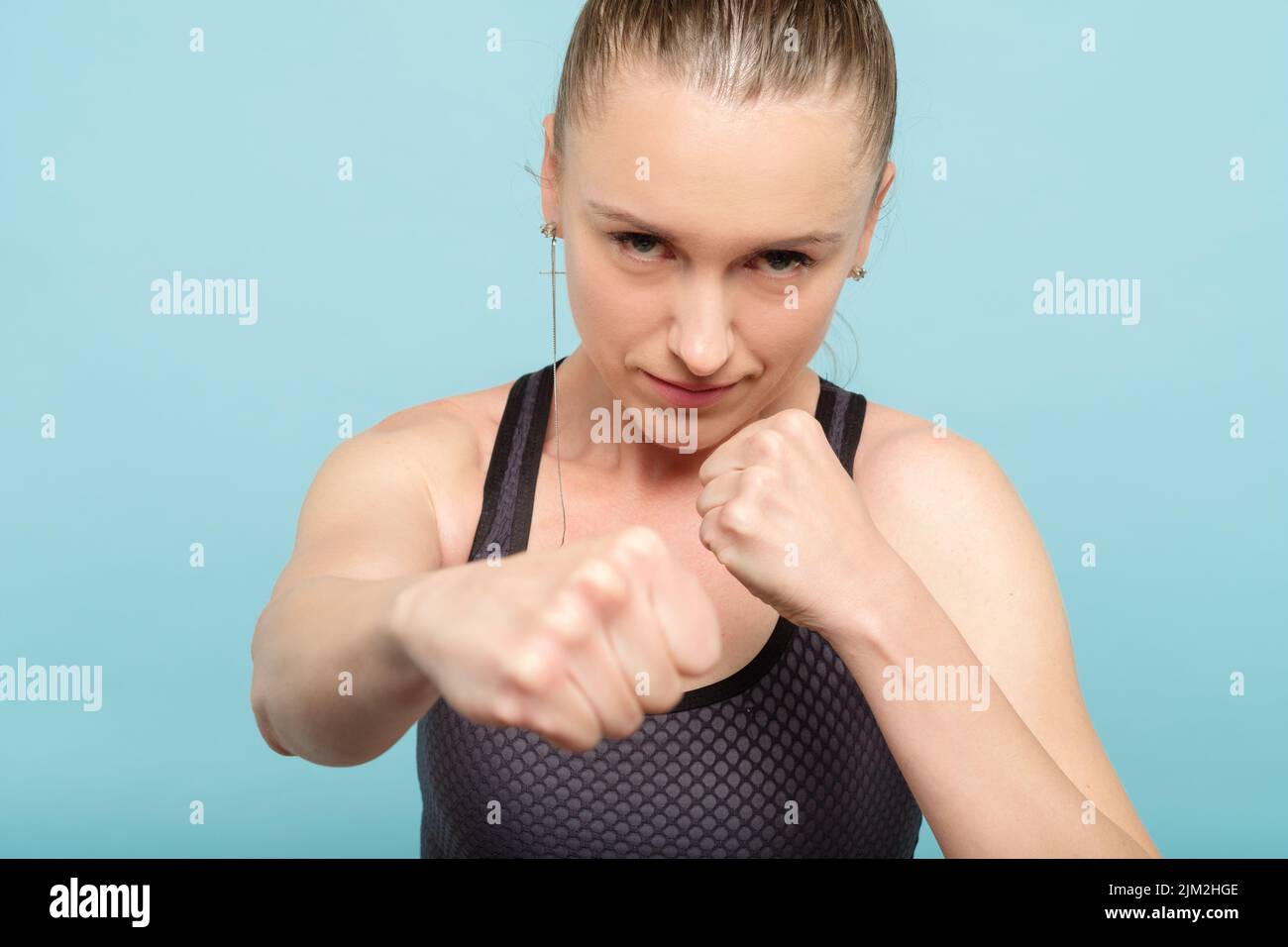 woman boxing straight blow strength training fight Stock Photo