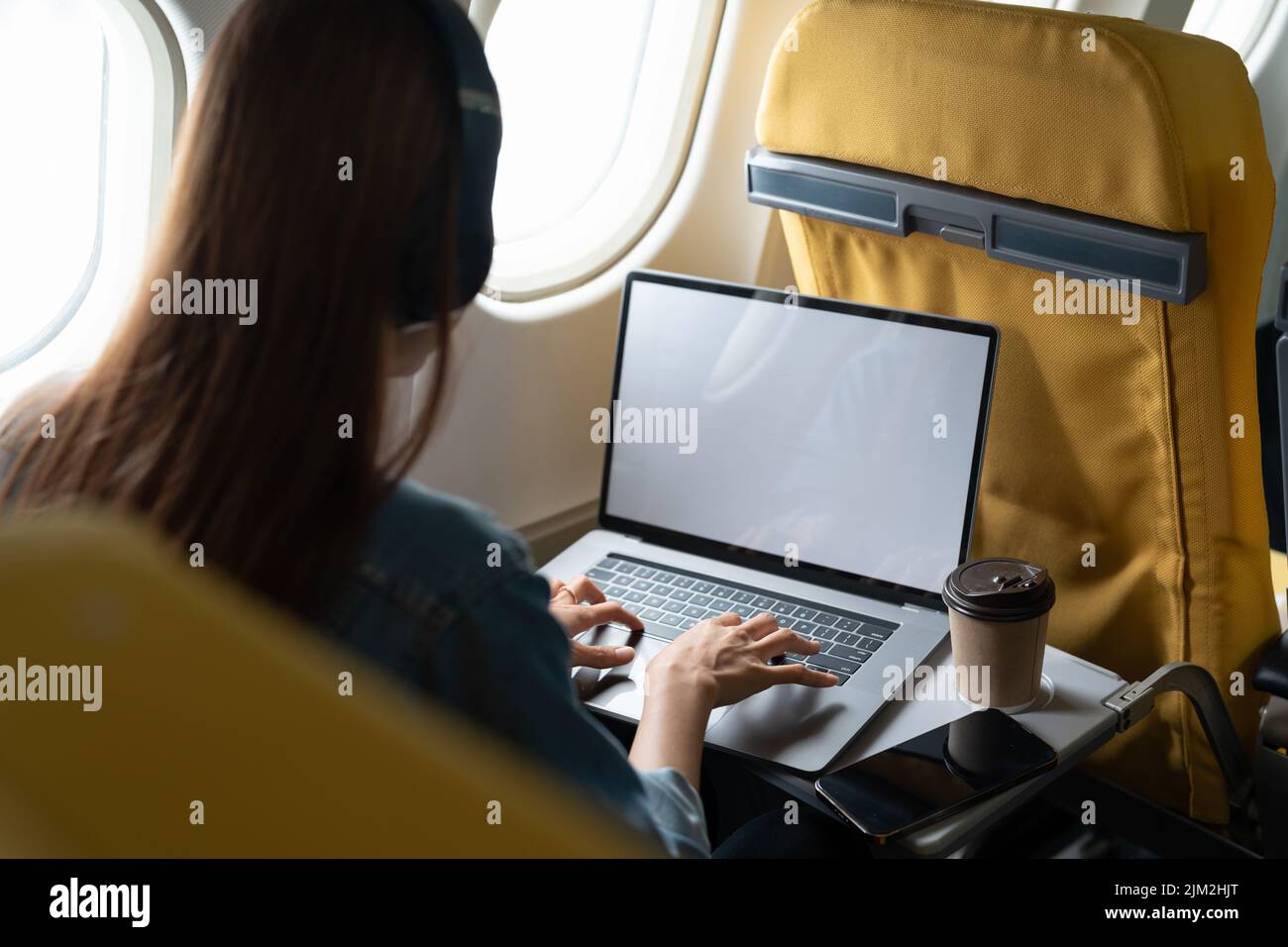 Beautiful asian travel woman using laptop computer in airplane Stock Photo