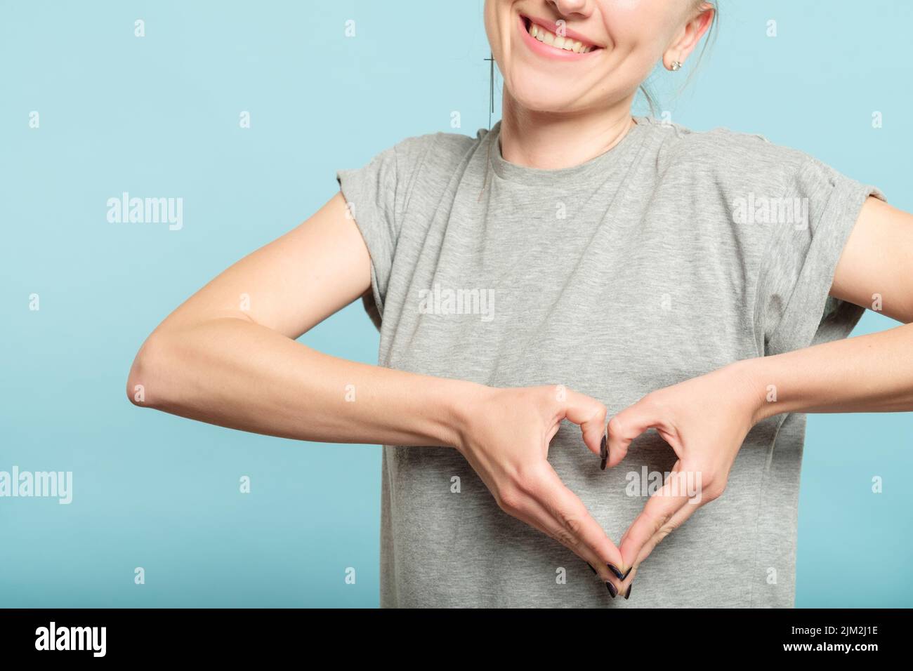 smiling woman heart shape hands gesture sign Stock Photo