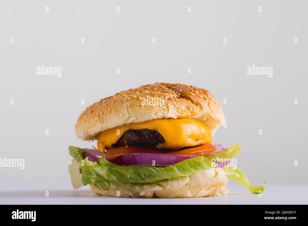 Close-up of burger against gray background with copy space. unaltered, food, studio shot and unhealthy food concept, Stock Photo