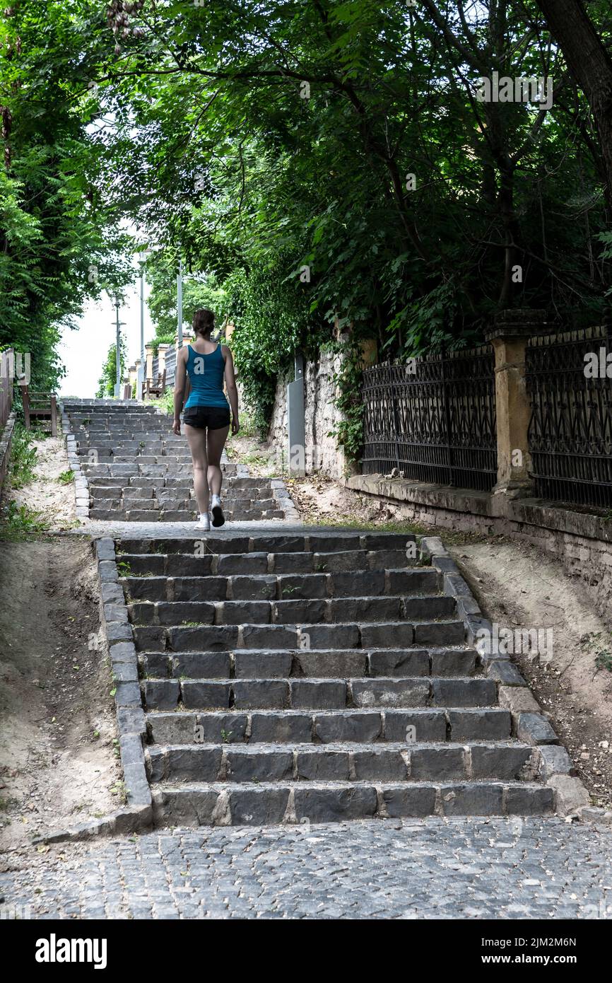 Woman running stairs fear hi-res stock photography and images - Alamy