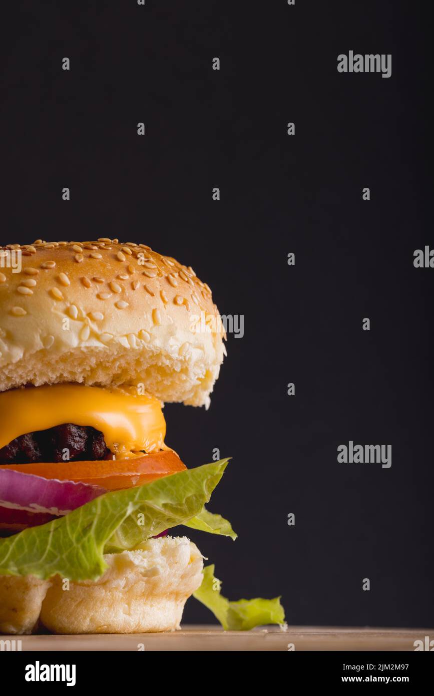 Close-up of fresh burger against gray background, copy space. unaltered, food, snack, fast food, studio shot and unhealthy food concept, Stock Photo
