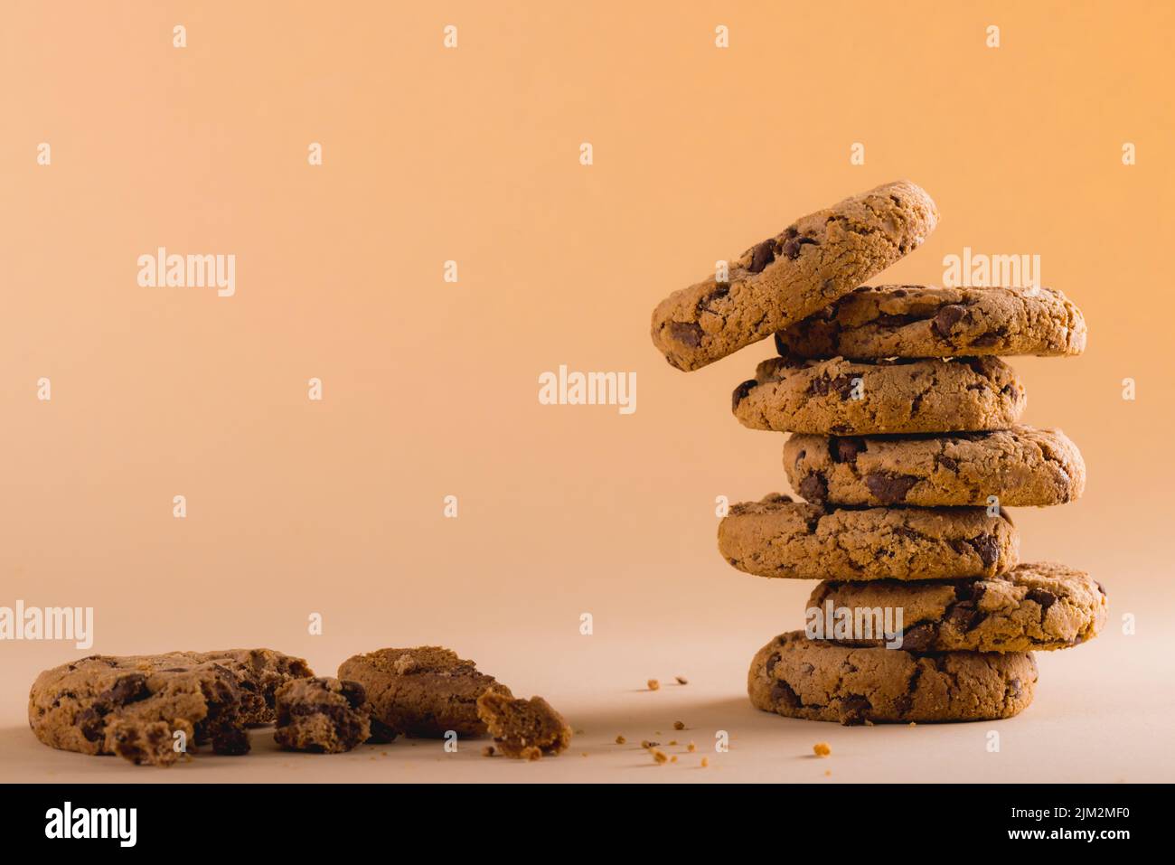 Stack of cookies on brown background with copy space. unaltered, food, baked, studio shot and snack. Stock Photo