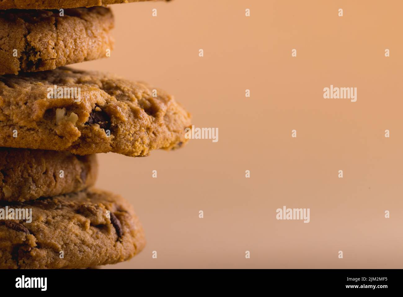 Close-up of stacked cookies against brown background with copy space. unaltered, food, baked, studio shot and snack. Stock Photo