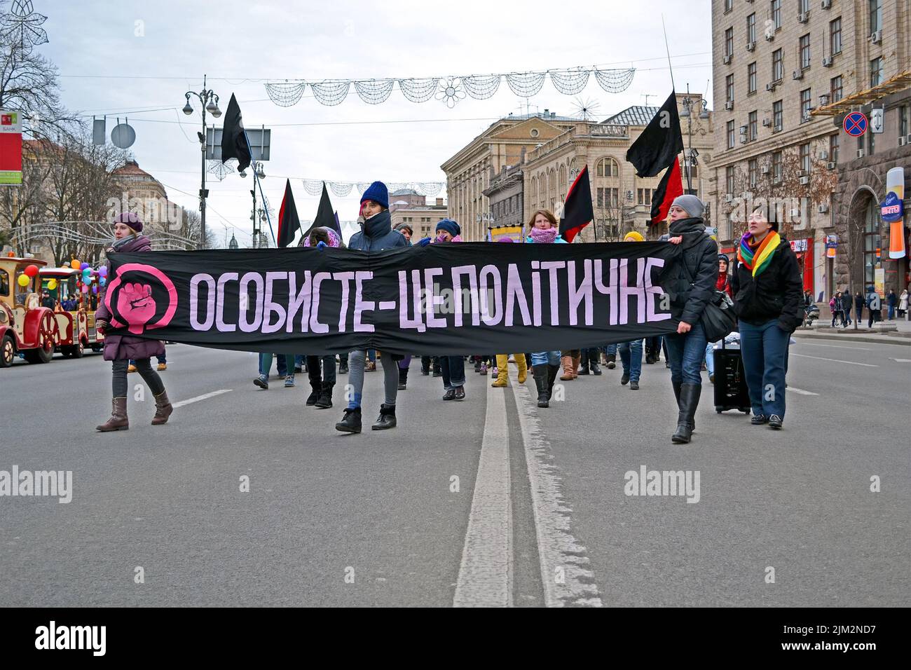 Youth demonstration on Kreshatik in Kiev, Ukraine. Girls carry the black and red flags with political slogans during demonstration. Stock Photo