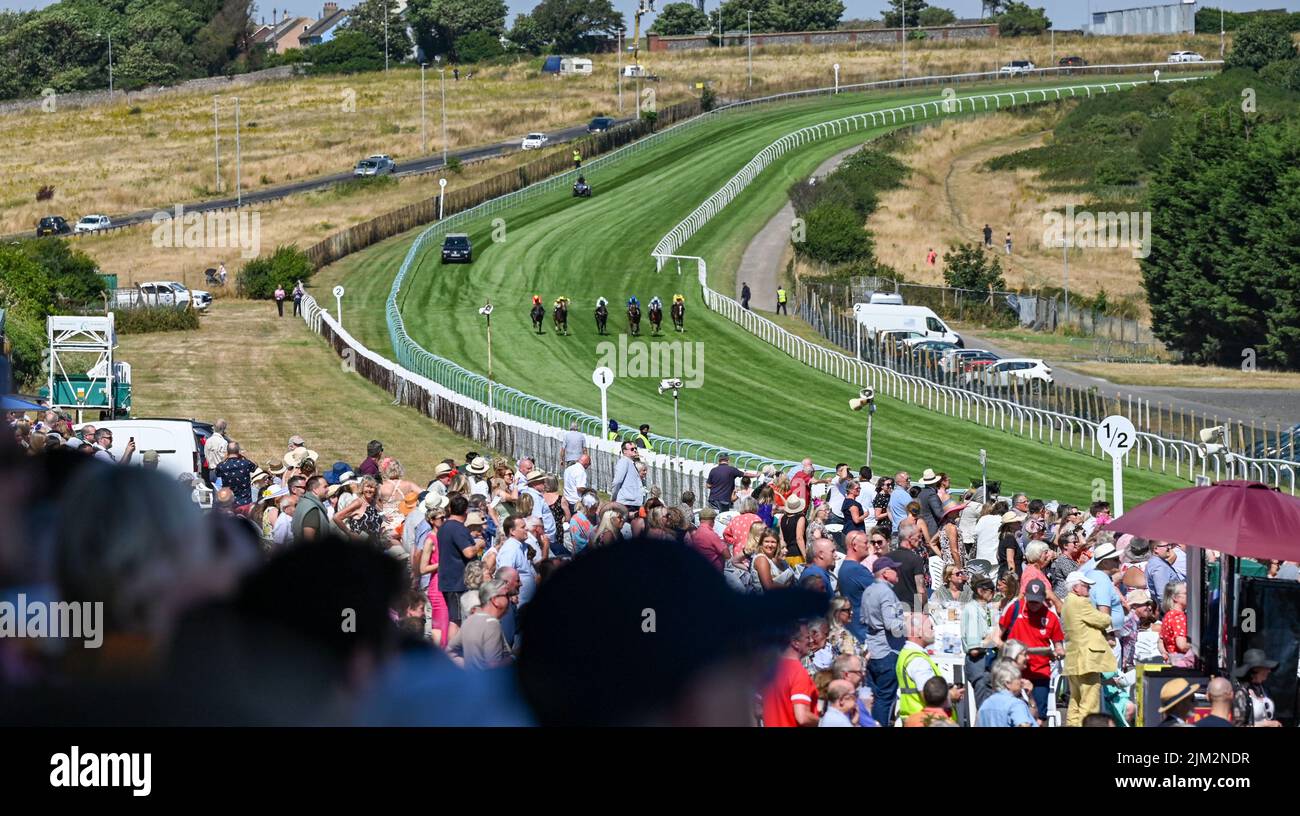 Brighton UK 4th August 2022 - Wisper ridden by Dougie Costello (pale blue 2nd from right) goes on to win The David Bennett Handicap Stakes at Brighton Racecourse's Ladies Day which is part of The Star Sports Festival of Racing held in August : Credit Simon Dack / Alamy Live News Stock Photo