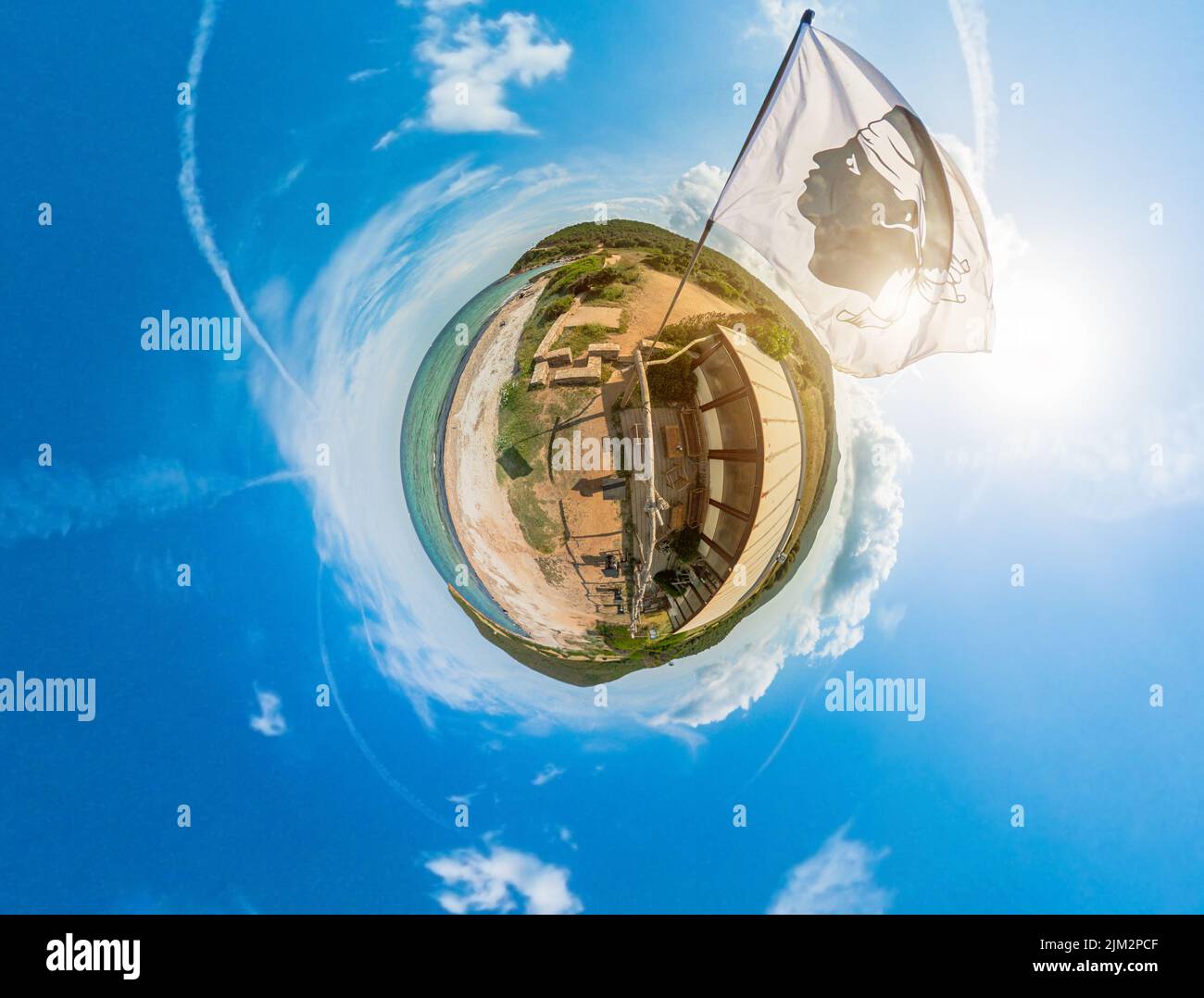Tiny Planet of the national waving flag of Corsica island in France. Aerial view in cloudy sky of a little planet earth of Corsica island. 360 degrees Stock Photo