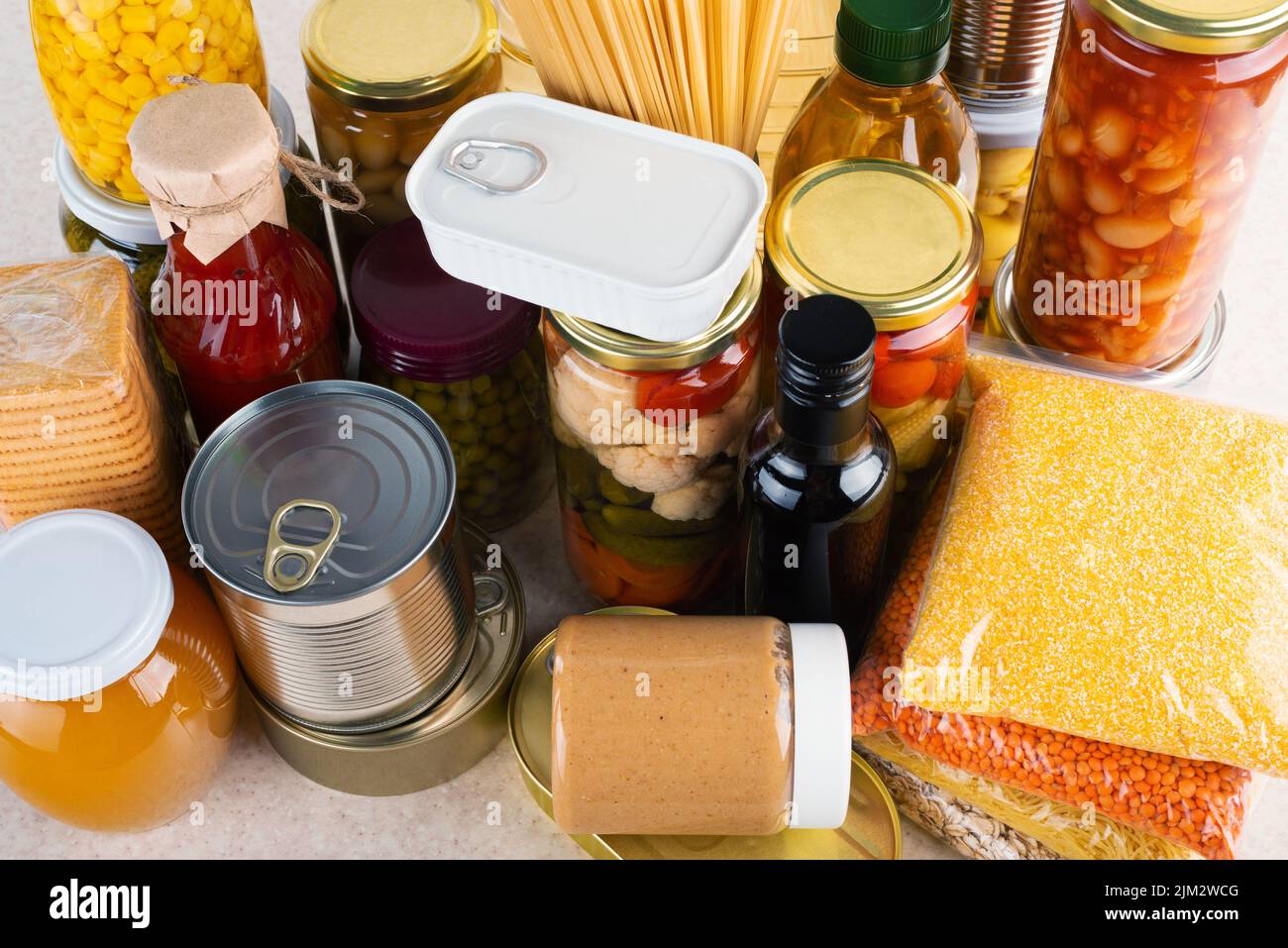 Emergency survival food set on white kitchen table high angle view Stock Photo