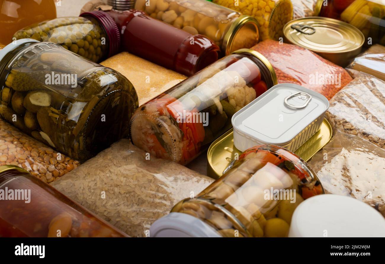 Emergency survival groceries on kitchen table closeup Stock Photo