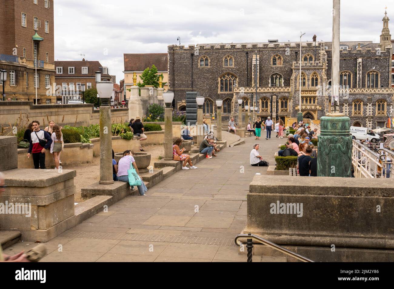 People sitting at the top of Norwich famous market on a summers day Stock Photo
